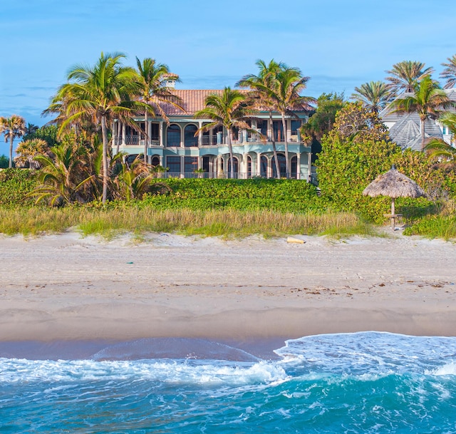 exterior space featuring a beach view and a water view