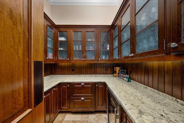 bar featuring ornamental molding, light stone countertops, and wine cooler