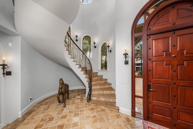 entryway with a towering ceiling