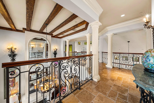 hallway with ornamental molding, beam ceiling, and ornate columns