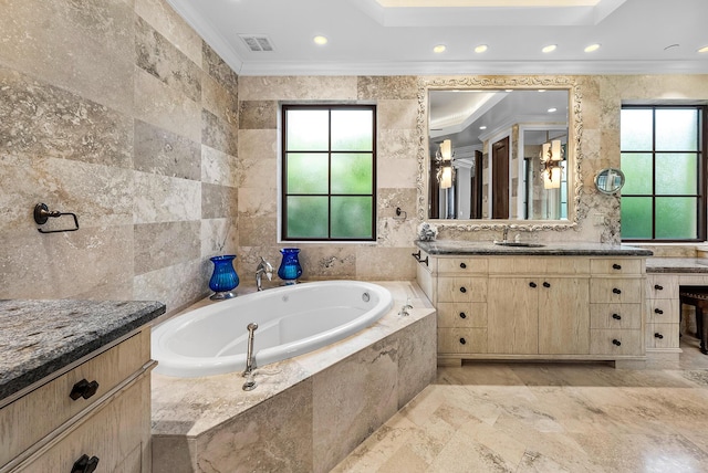 bathroom featuring crown molding, vanity, tile walls, and tiled tub