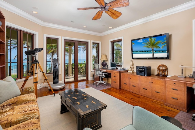 living room featuring ornamental molding, ceiling fan, light wood-type flooring, and french doors