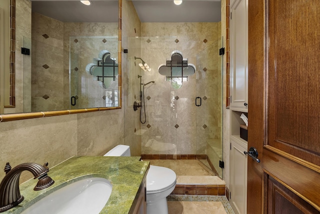 bathroom with vanity, toilet, and a shower with shower door