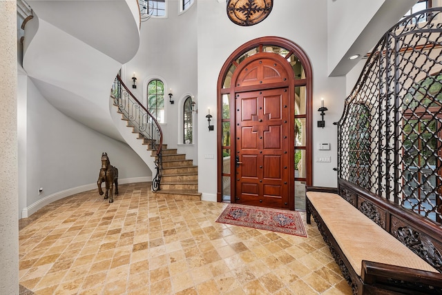 entryway featuring a towering ceiling