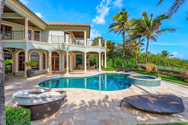 view of swimming pool with an in ground hot tub and a patio area