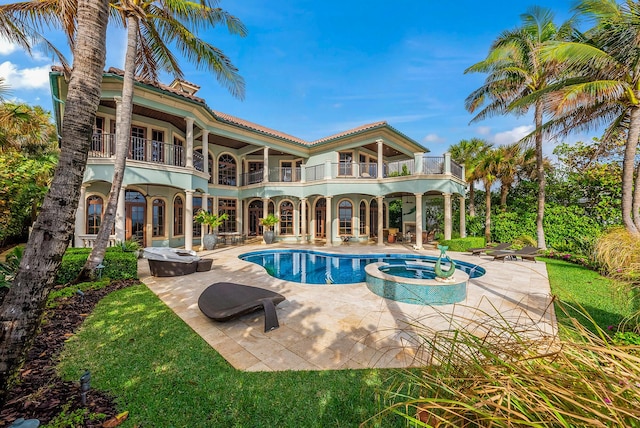 view of pool with an in ground hot tub and a patio area