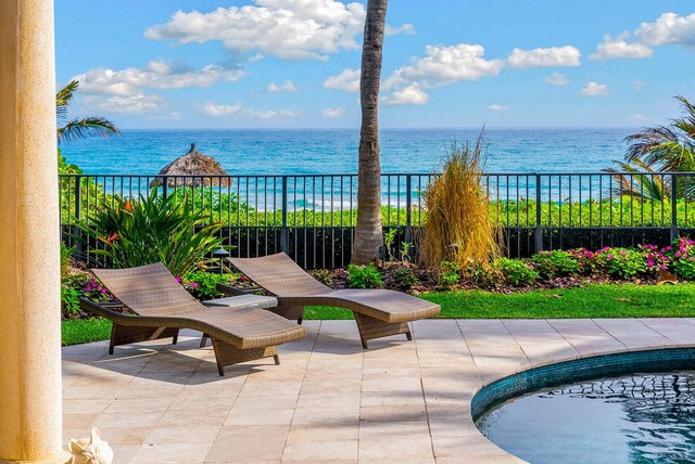 exterior space featuring a balcony and a water view