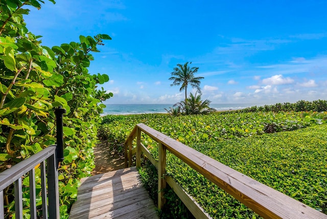 surrounding community with a view of the beach and a water view