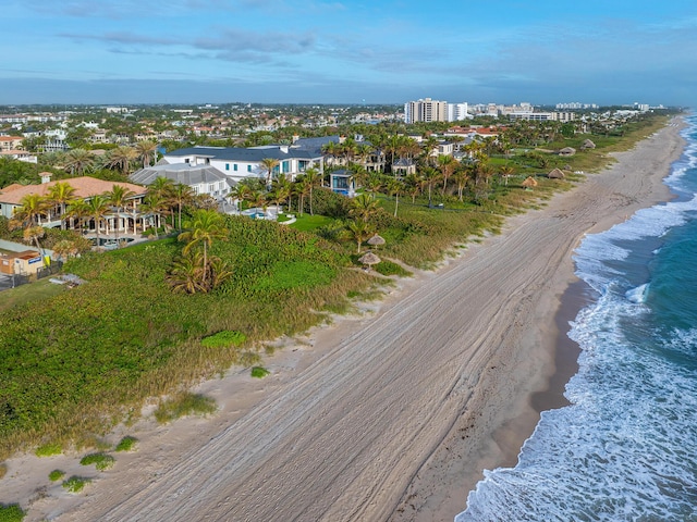 drone / aerial view featuring a water view and a beach view