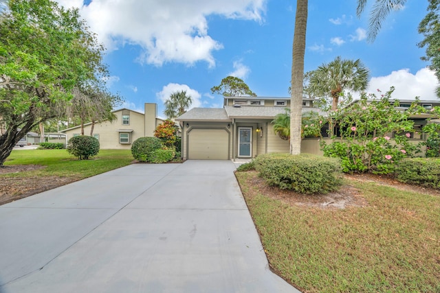 view of front of property featuring a garage and a front lawn