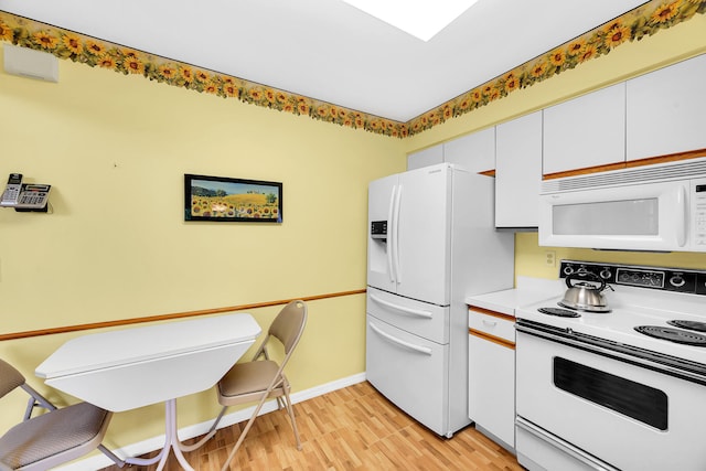 kitchen featuring white cabinets, white appliances, and light hardwood / wood-style floors