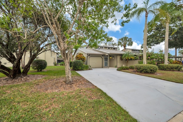 ranch-style home with a garage and a front lawn