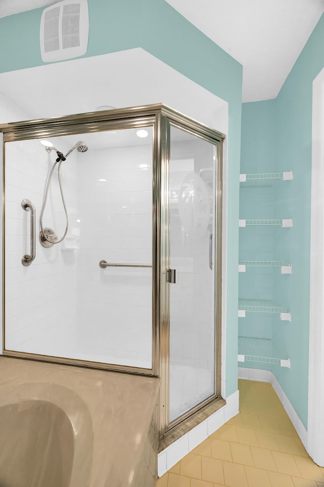 bathroom featuring tile patterned flooring and walk in shower