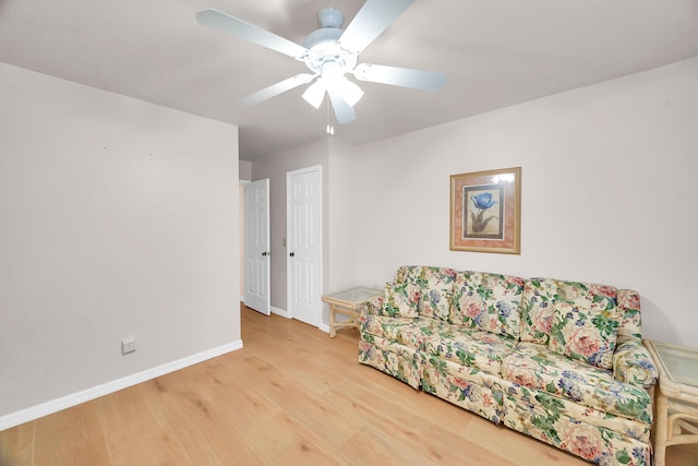 living area featuring ceiling fan and hardwood / wood-style flooring