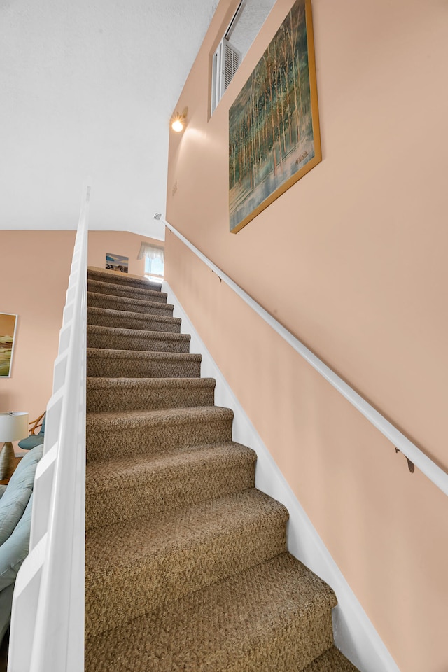 stairs with vaulted ceiling