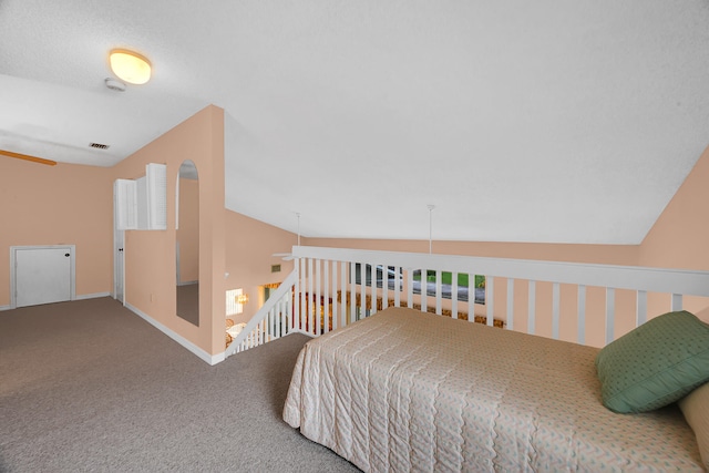 carpeted bedroom with lofted ceiling