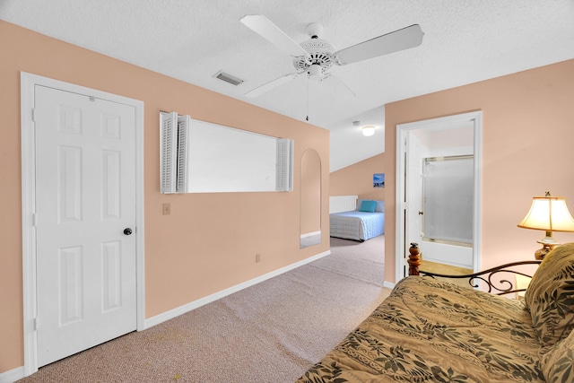 bedroom with ceiling fan, light colored carpet, and a textured ceiling