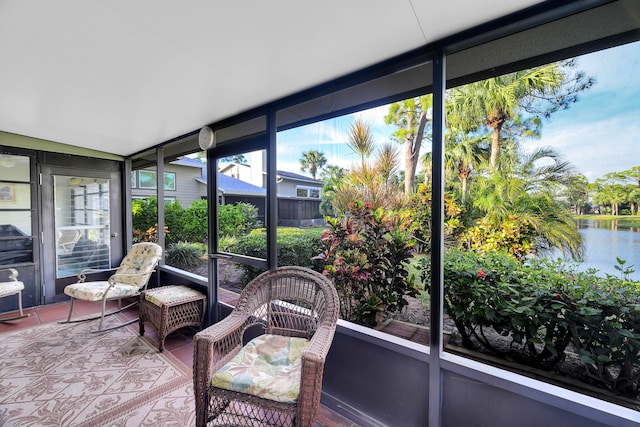 sunroom / solarium featuring a water view