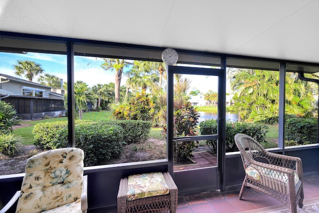 sunroom / solarium featuring a water view