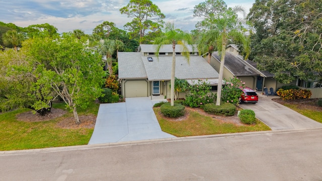 view of front of home with a front yard and a garage