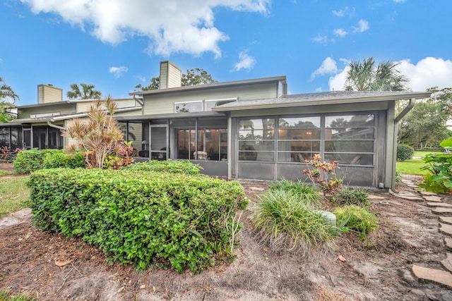 back of property featuring a sunroom