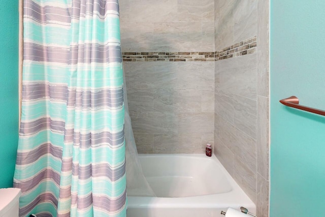 bathroom with shower / bath combination with curtain