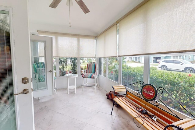 sunroom featuring ceiling fan and plenty of natural light