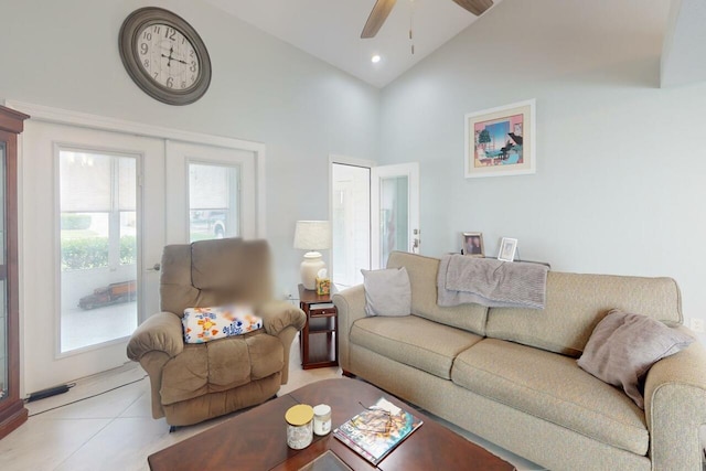 living room with ceiling fan, light tile patterned flooring, and high vaulted ceiling