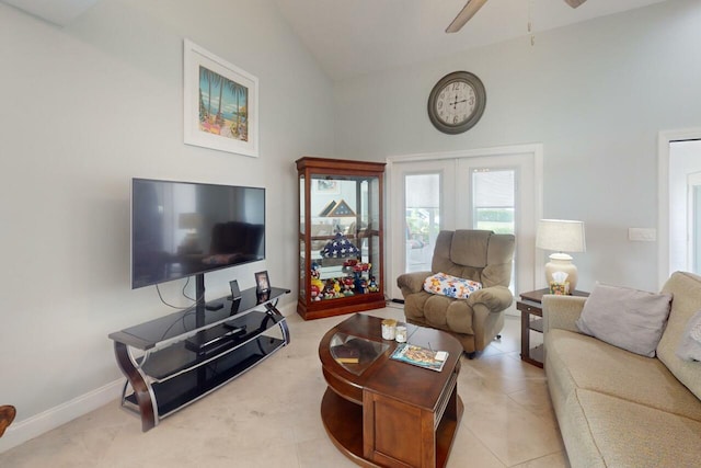 tiled living room featuring ceiling fan and high vaulted ceiling