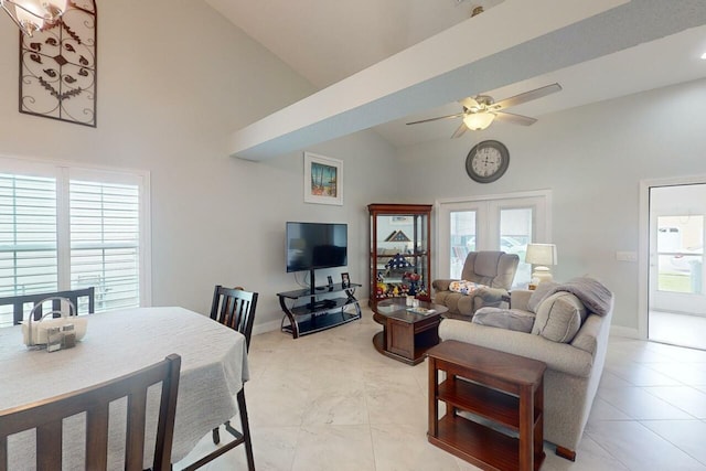 living room featuring ceiling fan, light tile patterned floors, and high vaulted ceiling