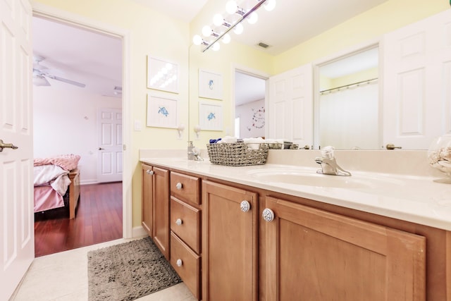 bathroom featuring vanity, ceiling fan, and wood-type flooring