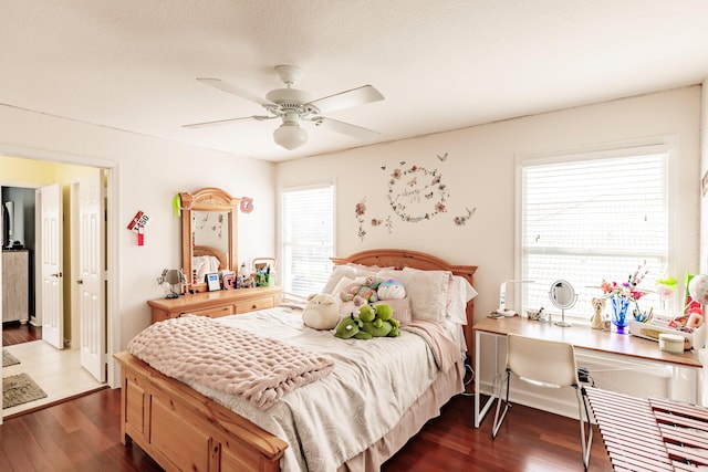 bedroom featuring multiple windows, ceiling fan, and dark hardwood / wood-style flooring