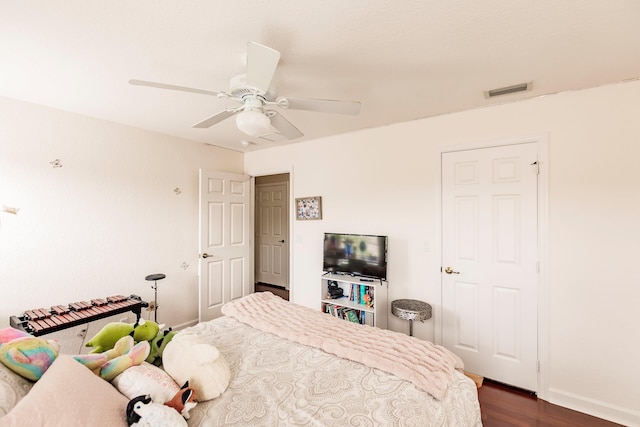 bedroom featuring ceiling fan and dark wood-type flooring