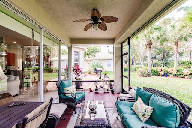 sunroom featuring ceiling fan