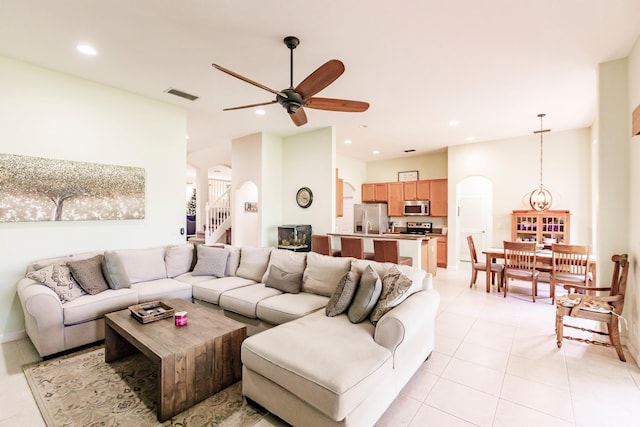 tiled living room with ceiling fan