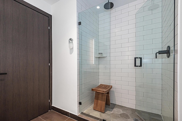 bathroom with tile patterned floors and a shower with shower door