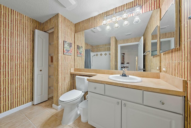 bathroom featuring vanity, tile patterned floors, a shower with curtain, toilet, and a textured ceiling