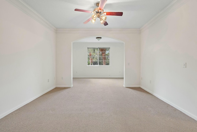 carpeted empty room featuring ceiling fan and ornamental molding