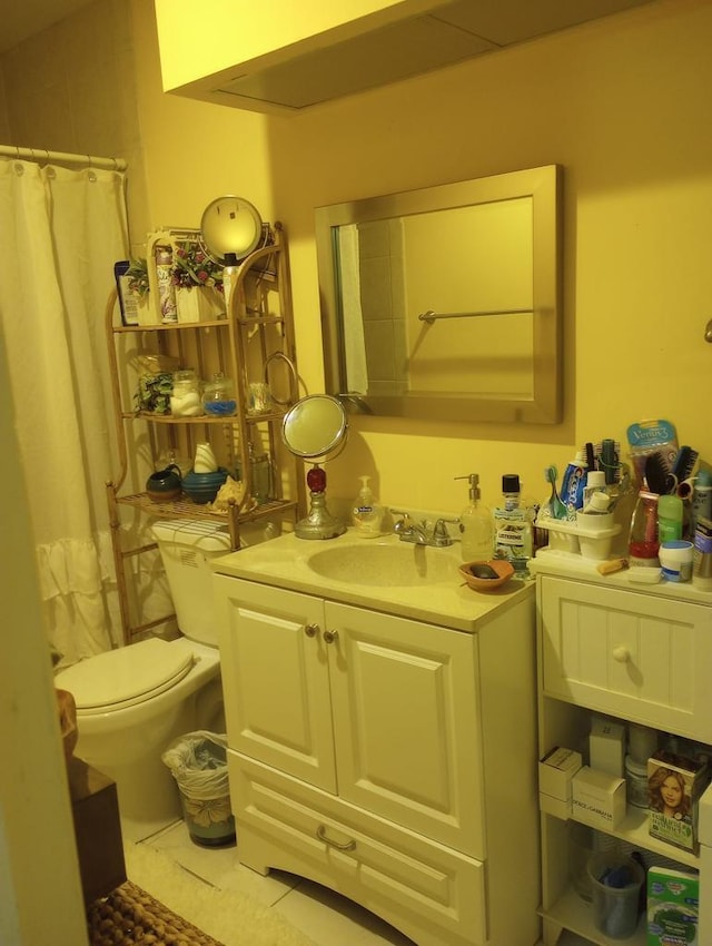 bathroom with tile patterned floors, vanity, and toilet