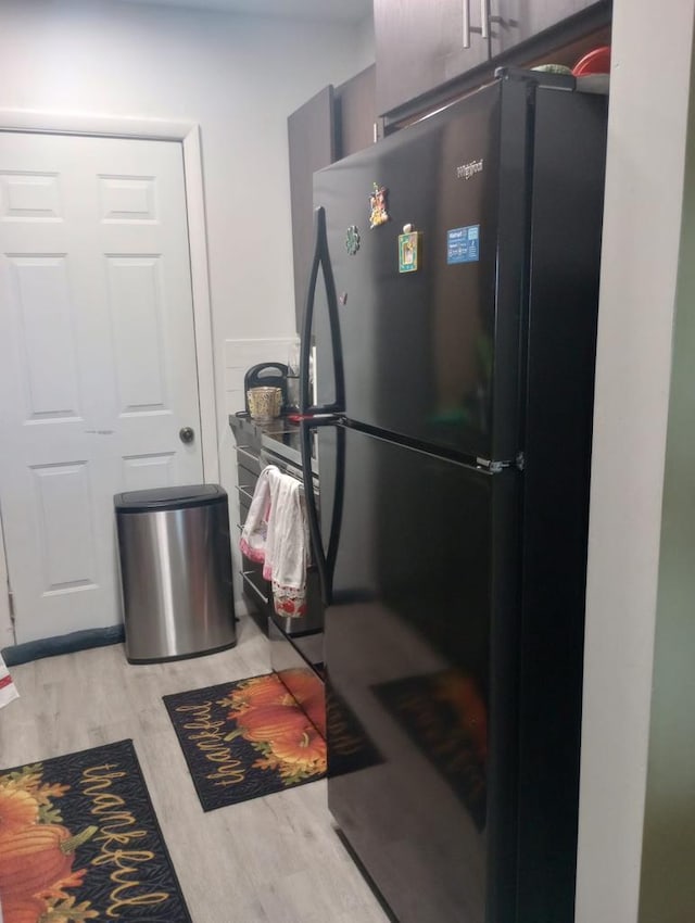 kitchen featuring black refrigerator and light wood-type flooring