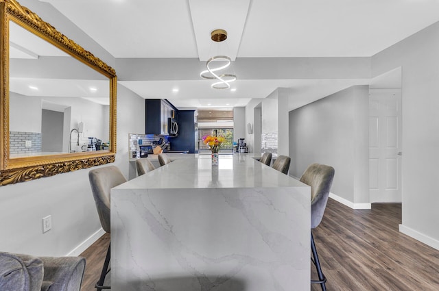 dining room featuring sink and dark hardwood / wood-style floors