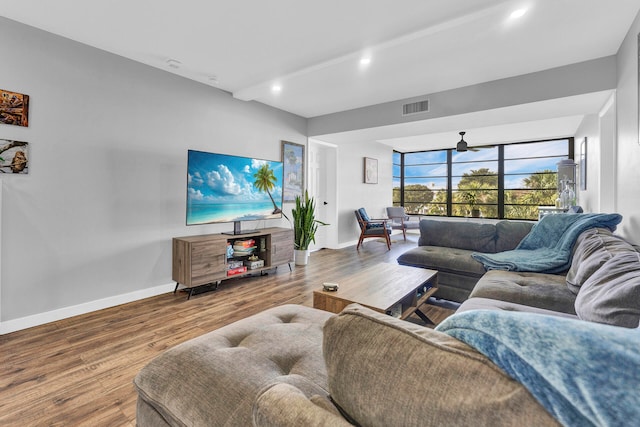 living room featuring hardwood / wood-style floors and ceiling fan