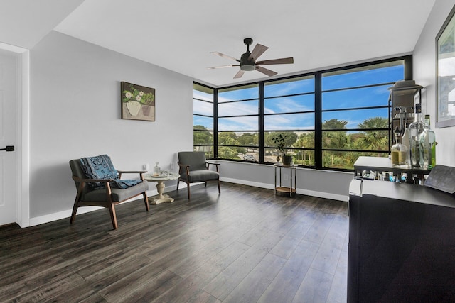 sitting room with ceiling fan and dark hardwood / wood-style flooring