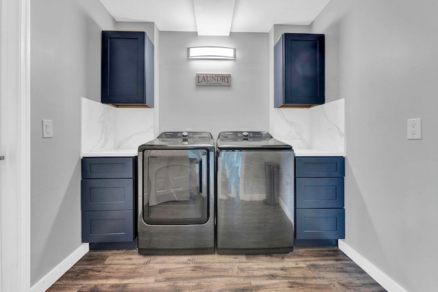 clothes washing area featuring dark hardwood / wood-style flooring, cabinets, and separate washer and dryer