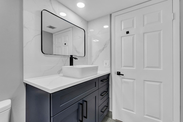 bathroom with vanity and toilet