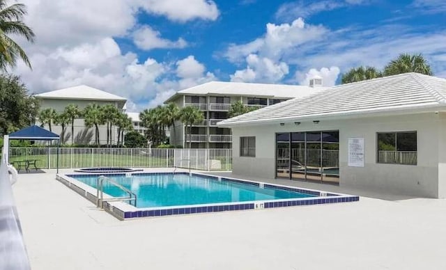 view of pool featuring a patio area and a community hot tub