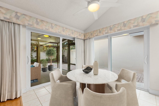 dining space featuring light tile patterned floors, a textured ceiling, and vaulted ceiling