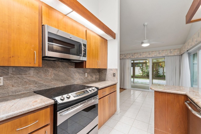 kitchen featuring tasteful backsplash, ceiling fan, light tile patterned flooring, and stainless steel appliances