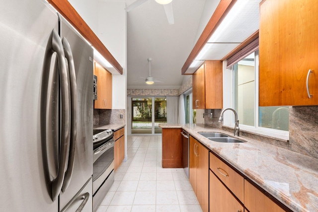 kitchen with sink, ceiling fan, light tile patterned floors, appliances with stainless steel finishes, and tasteful backsplash