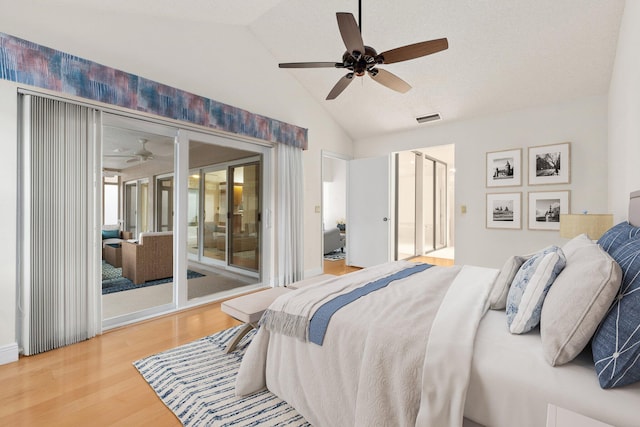 bedroom with ceiling fan, access to exterior, wood-type flooring, and lofted ceiling